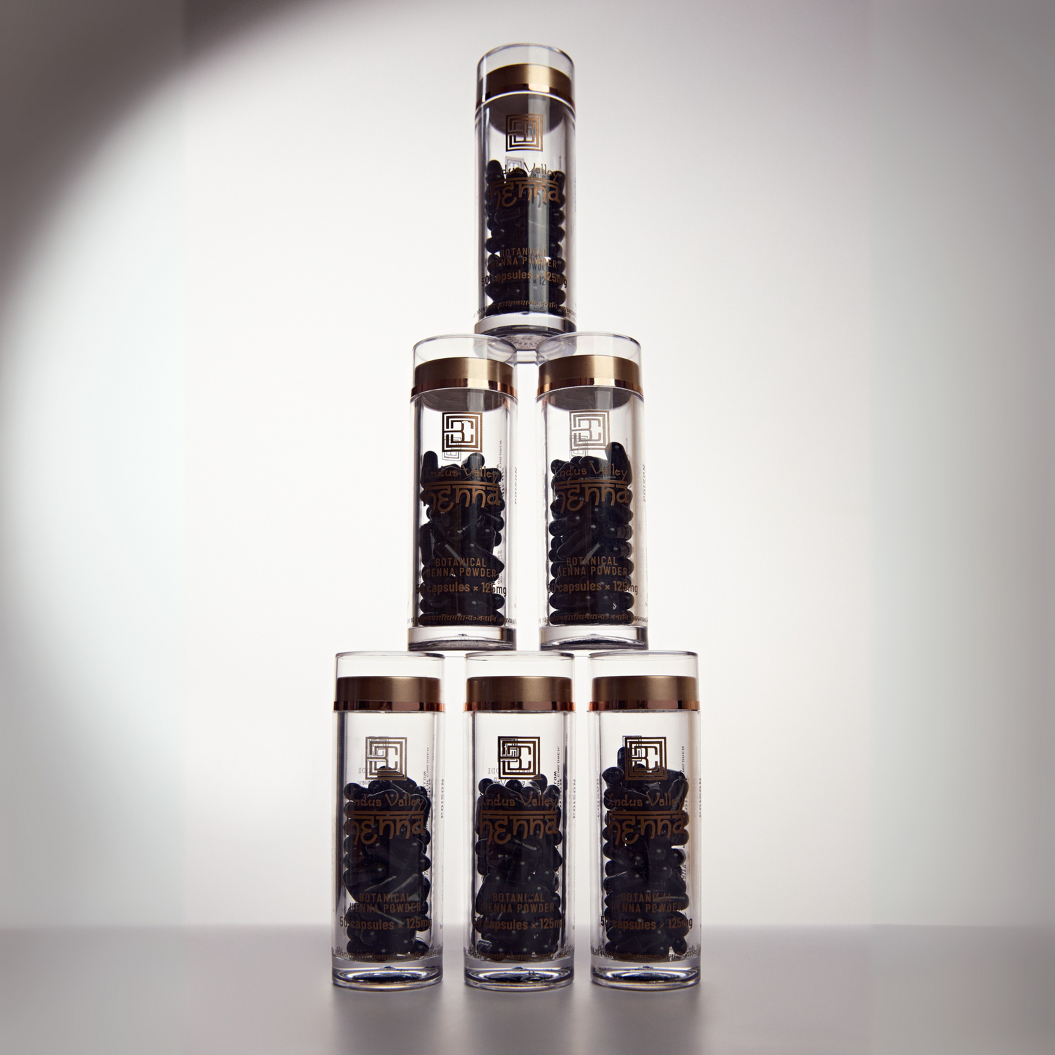 Stylised image of Henna Powder in packaging stacked on top of eachother